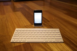 iPhone with apple wireless keyboard at desk